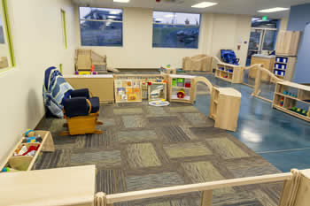 infant play area with toys and rug