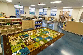 play area with toys and colorful rug