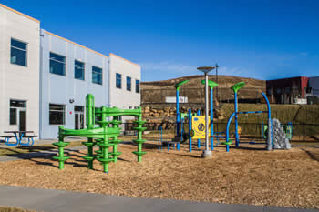 outdoor playground with blue and green equipment
